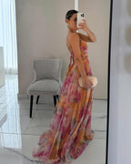 Floral print maxi dress in soft pastels, featuring adjustable straps and a flowing silhouette. 2