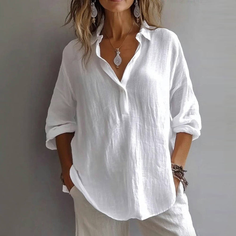A soft pink, elegant blouse for women with a relaxed fit and subtle ruffle details on the sleeves. 1