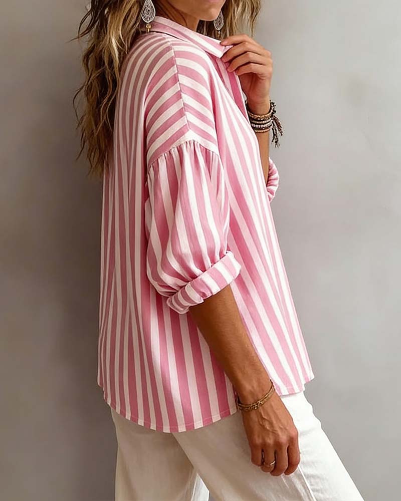 Light blue striped blouse with a relaxed fit and short sleeves. 1