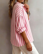 Light blue striped blouse with a relaxed fit and short sleeves. 1