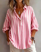 Light blue striped blouse with a relaxed fit and short sleeves. 2