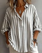 Light blue striped blouse with a relaxed fit and short sleeves. 3