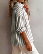 Light blue striped blouse with a relaxed fit and short sleeves. 4