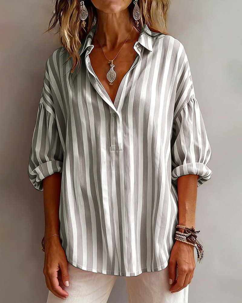 Light blue striped blouse with a relaxed fit and short sleeves. 5