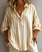 Light blue striped blouse with a relaxed fit and short sleeves. 6