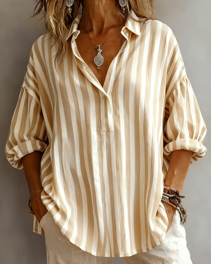 Light blue striped blouse with a relaxed fit and short sleeves. 6