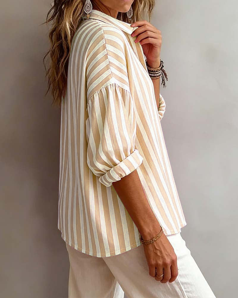 Light blue striped blouse with a relaxed fit and short sleeves. 7