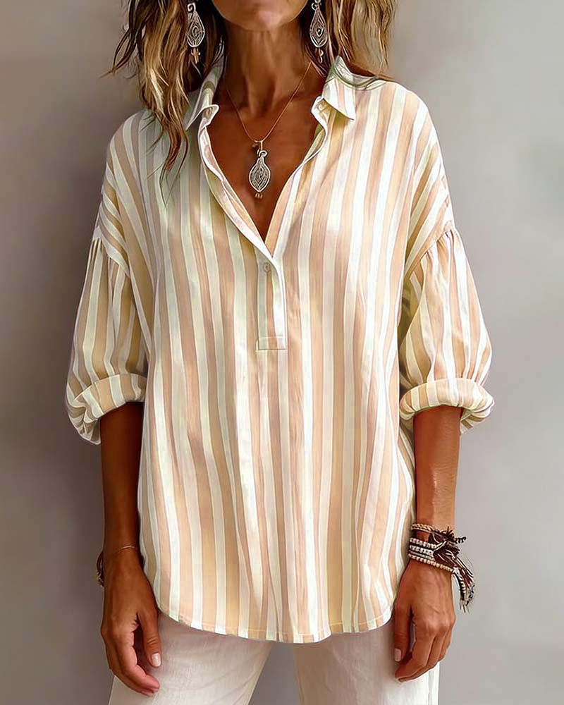 Light blue striped blouse with a relaxed fit and short sleeves. 8