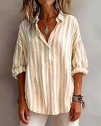 Light blue striped blouse with a relaxed fit and short sleeves. 8