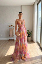 Floral print maxi dress in soft pastels, featuring adjustable straps and a flowing silhouette. 0
