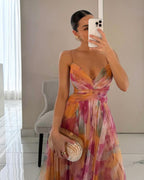 Floral print maxi dress in soft pastels, featuring adjustable straps and a flowing silhouette. 1