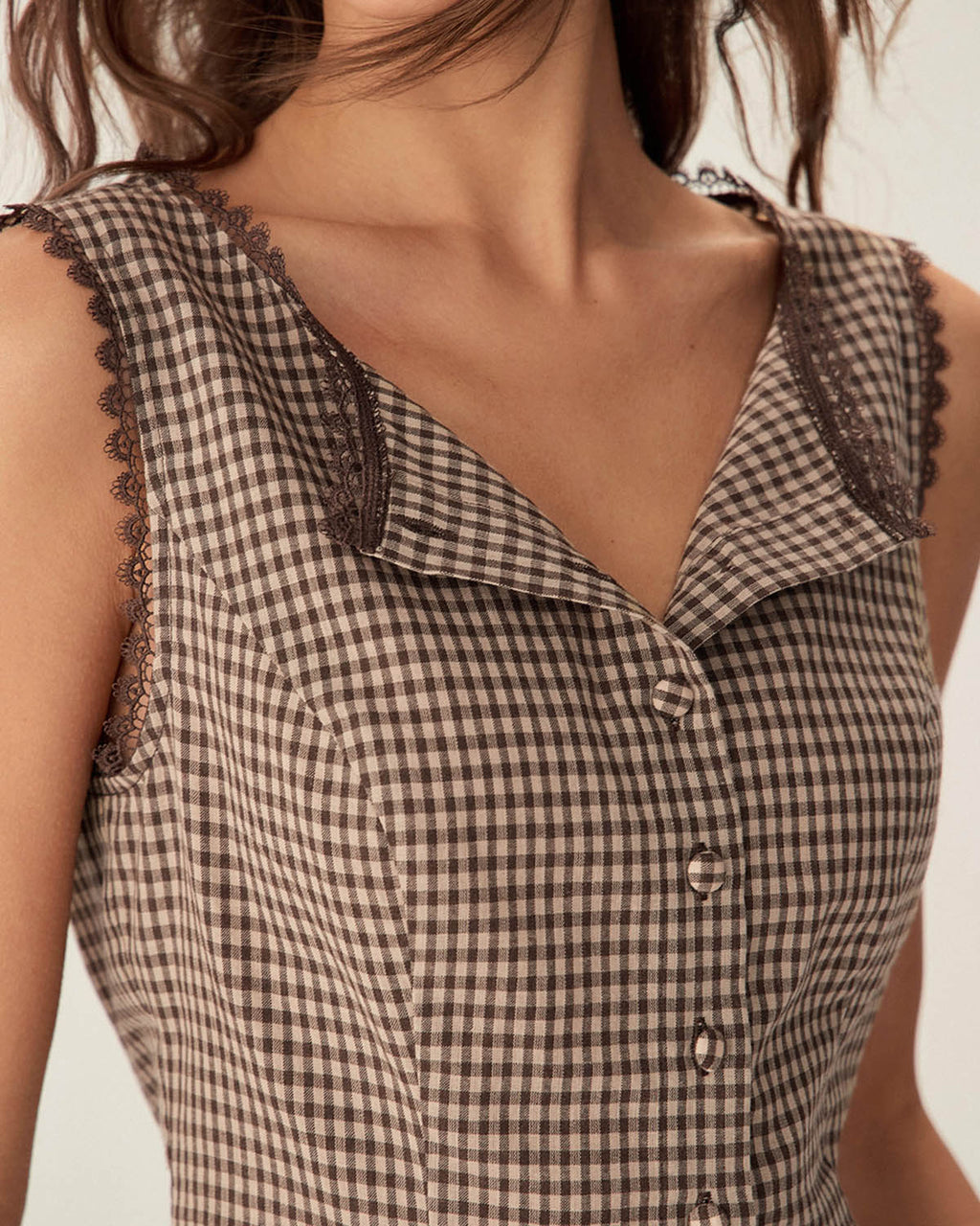 Brown plaid cotton vest with a single-breasted design and round neck. Casual style suitable for layering. 1