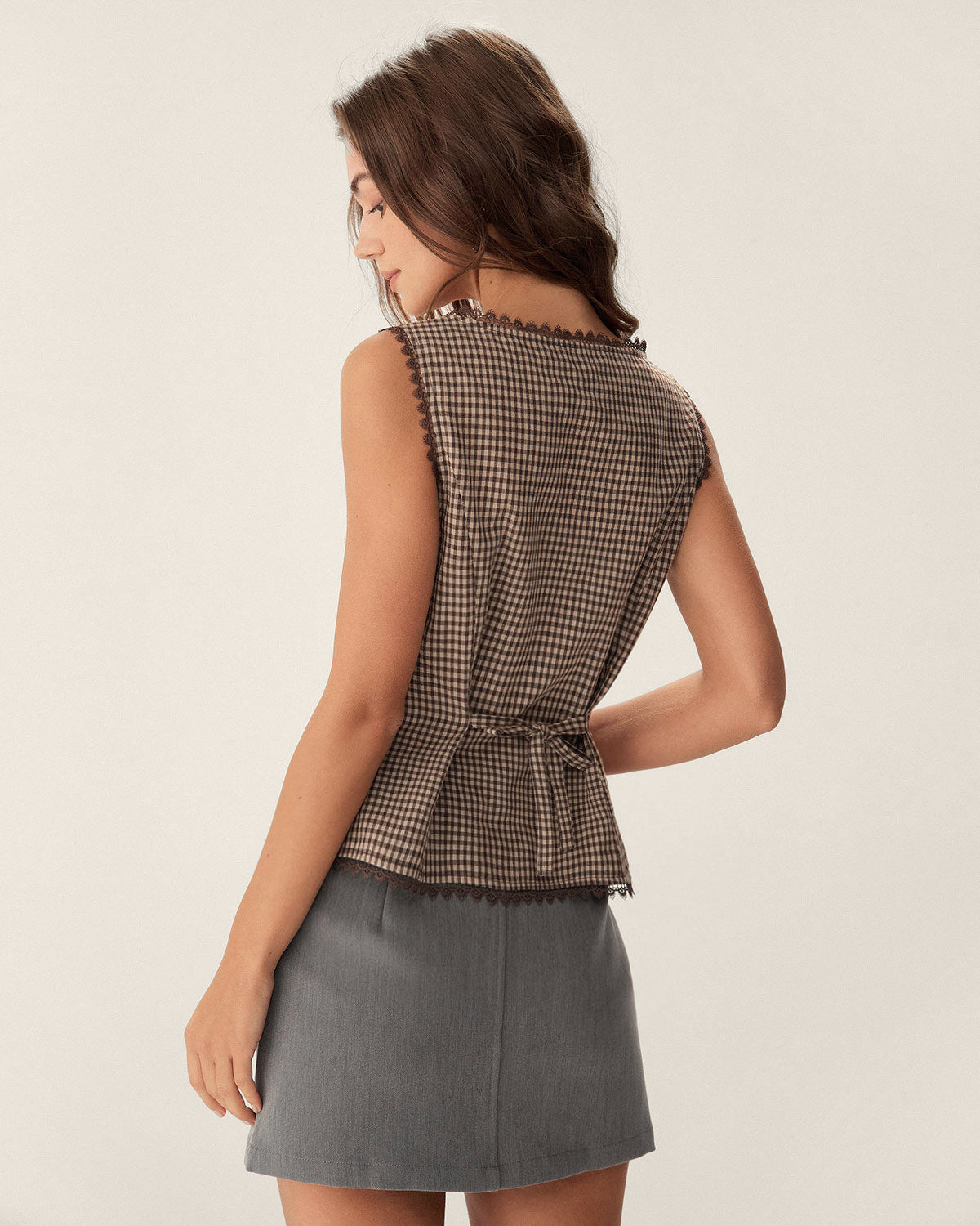 Brown plaid cotton vest with a single-breasted design and round neck. Casual style suitable for layering. 3