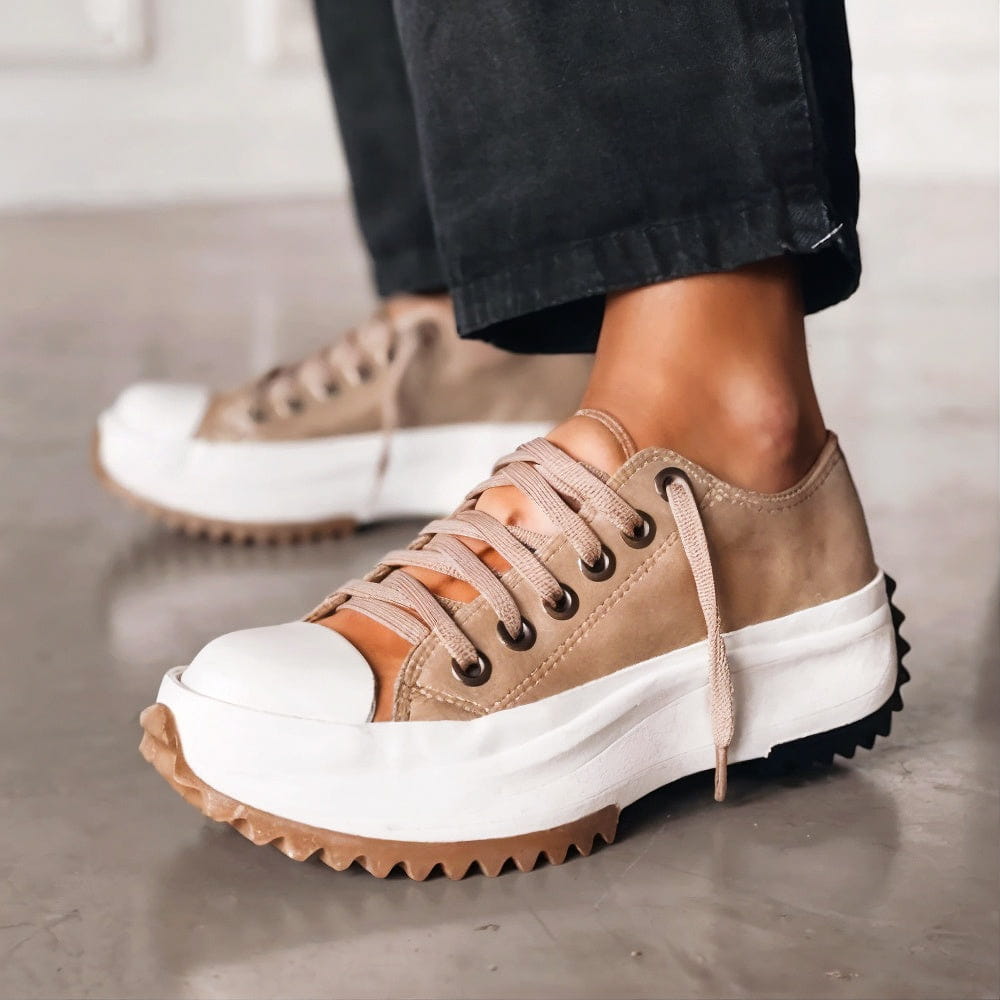White platform sneakers with a sleek, minimalist design and subtle textured accents. 0