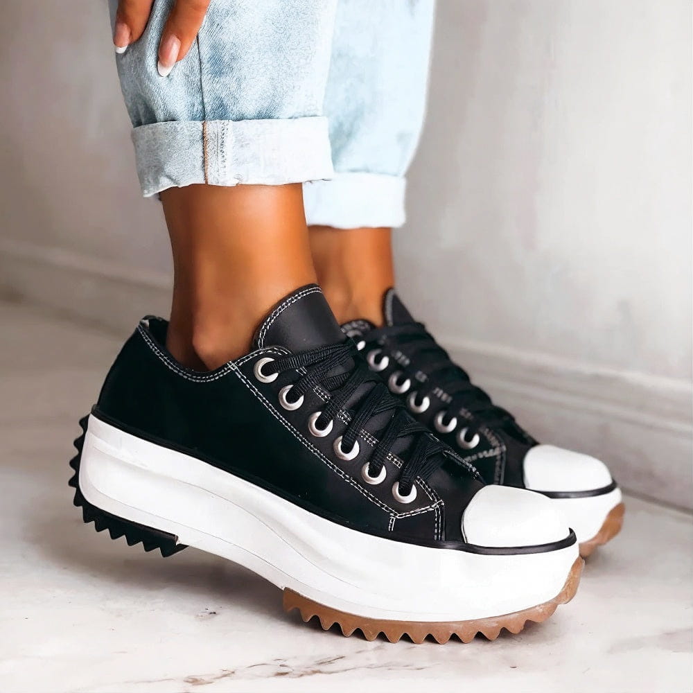White platform sneakers with a sleek, minimalist design and subtle textured accents. 2