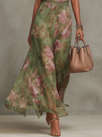 Eliza floral summer dress in pastel pink, featuring a halter neckline and a defined waist for a feminine silhouette. 3