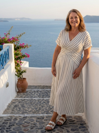 A navy blue midi dress with a V-neck, short sleeves, and a stylish cross waist detail. 2