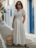 A navy blue midi dress with a V-neck, short sleeves, and a stylish cross waist detail. 4
