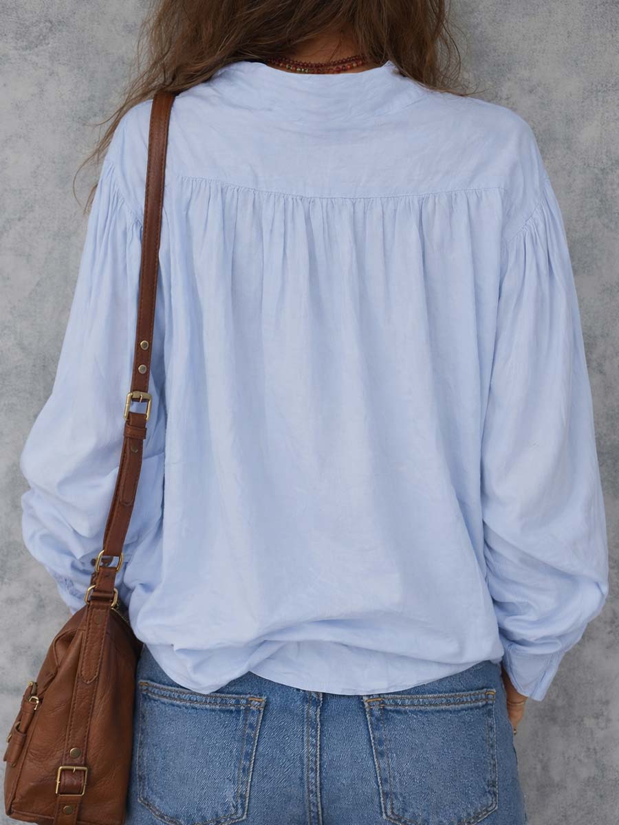 White cotton blouse with ruffle cuffs in a relaxed fit style. 3