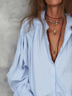 White cotton blouse with ruffle cuffs in a relaxed fit style. 4