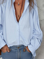 White cotton blouse with ruffle cuffs in a relaxed fit style. 5