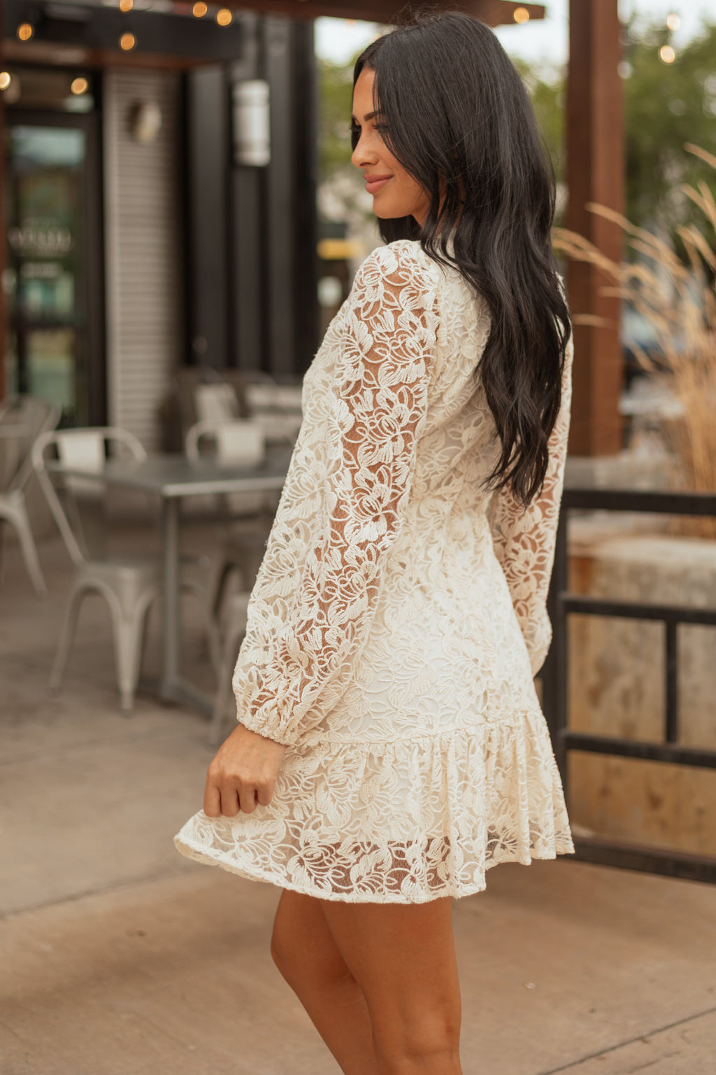 A white floral lace mini dress with sheer long sleeves, featuring a romantic and elegant style, perfect for weddings. 3