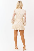 A white floral lace mini dress with sheer long sleeves, featuring a romantic and elegant style, perfect for weddings. 5