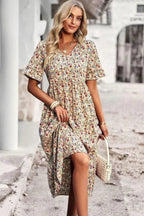 Light blue floral summer dress with a flowing, relaxed fit and delicate straps. Perfect for warm-weather outings. 7