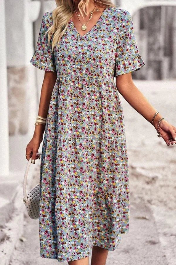 Light blue floral summer dress with a flowing, relaxed fit and delicate straps. Perfect for warm-weather outings. 9