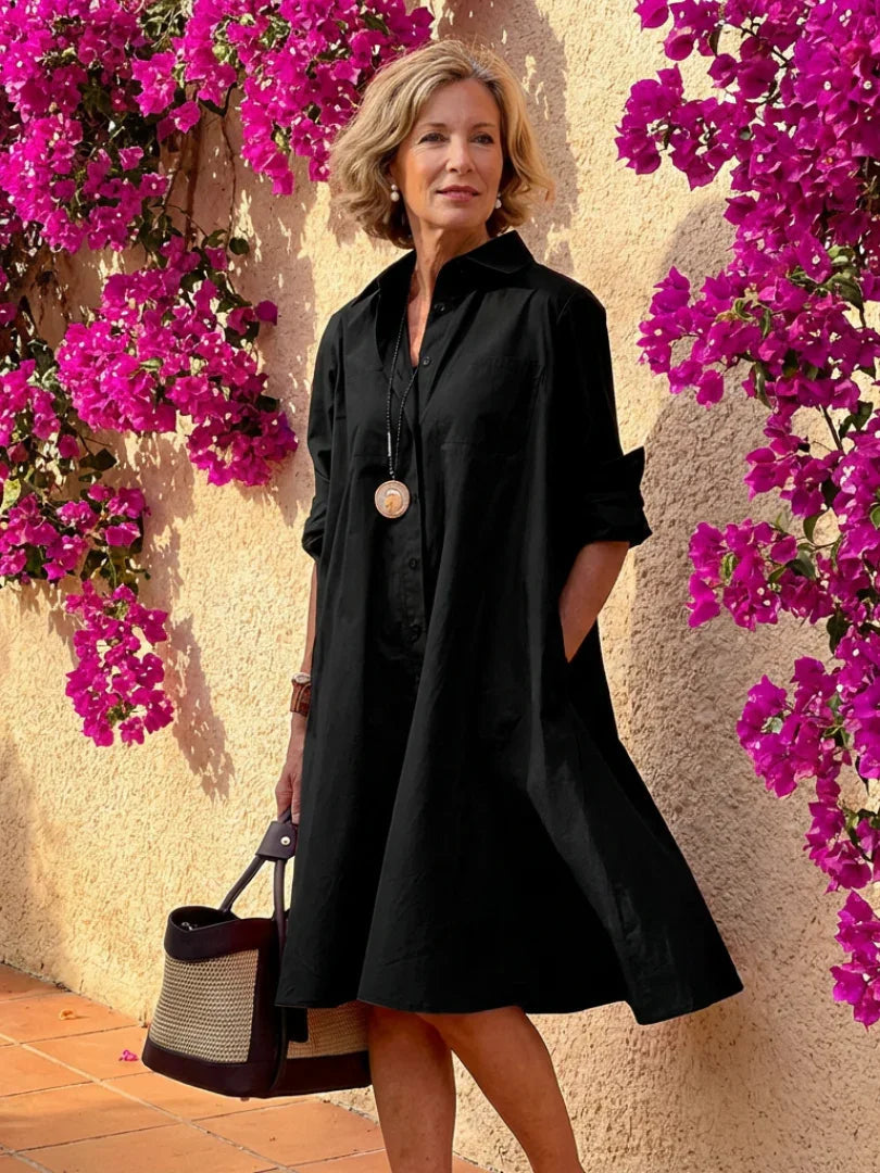 Light blue midi shirt dress with a button front, collared neckline, and long sleeves in a relaxed fit. 0