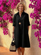 Light blue midi shirt dress with a button front, collared neckline, and long sleeves in a relaxed fit. 1