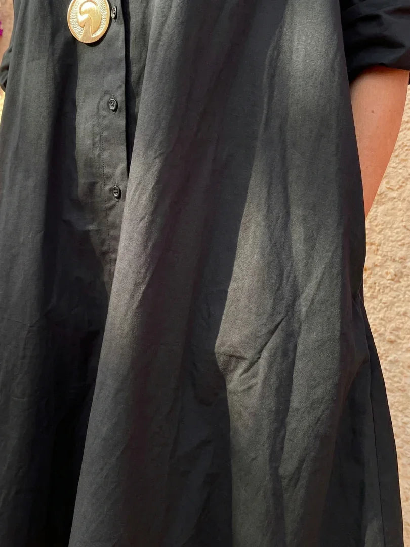 Light blue midi shirt dress with a button front, collared neckline, and long sleeves in a relaxed fit. 2