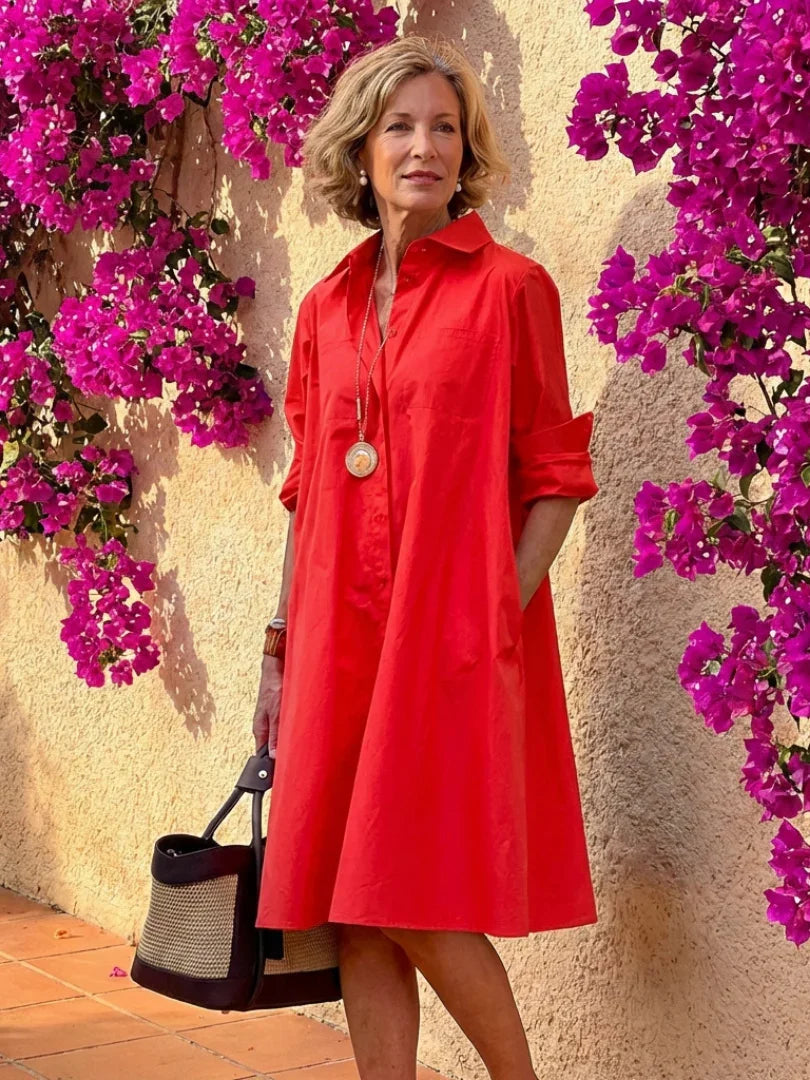 Light blue midi shirt dress with a button front, collared neckline, and long sleeves in a relaxed fit. 3