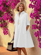 Light blue midi shirt dress with a button front, collared neckline, and long sleeves in a relaxed fit. 4