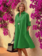 Light blue midi shirt dress with a button front, collared neckline, and long sleeves in a relaxed fit. 6