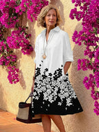 Light blue midi shirt dress with a button front, collared neckline, and long sleeves in a relaxed fit. 7