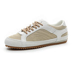 White leather trainers with a sleek, minimalist design and subtle perforations for breathability. 0