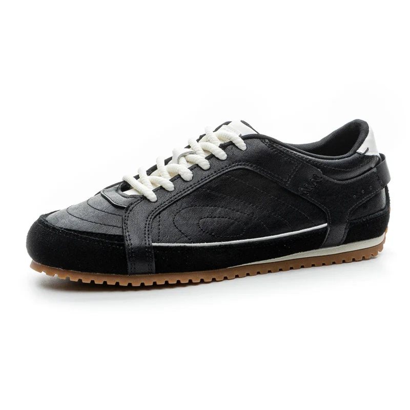 White leather trainers with a sleek, minimalist design and subtle perforations for breathability. 1