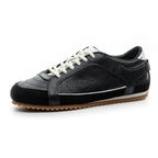 White leather trainers with a sleek, minimalist design and subtle perforations for breathability. 1