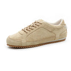White leather trainers with a sleek, minimalist design and subtle perforations for breathability. 2