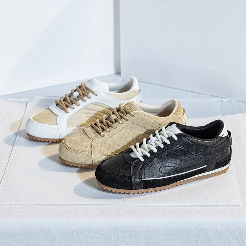 White leather trainers with a sleek, minimalist design and subtle perforations for breathability. 3