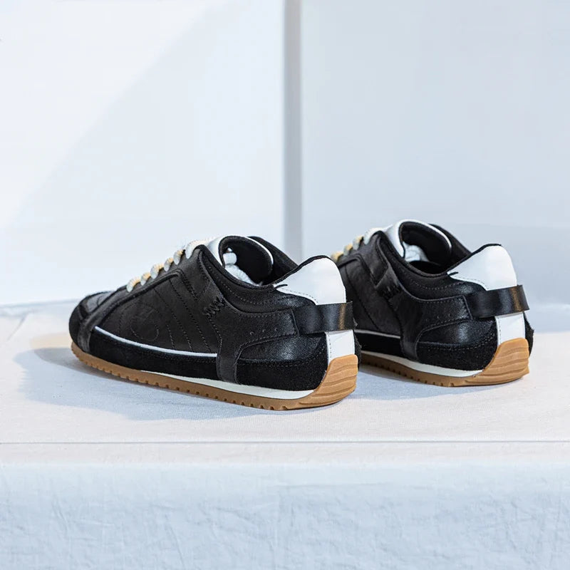 White leather trainers with a sleek, minimalist design and subtle perforations for breathability. 4