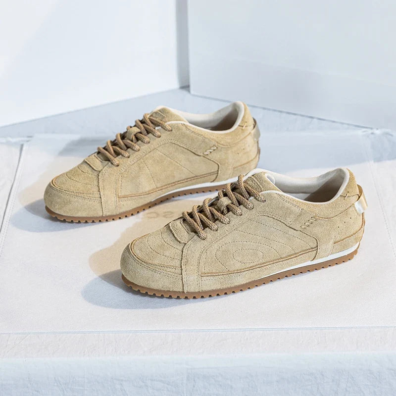 White leather trainers with a sleek, minimalist design and subtle perforations for breathability. 5