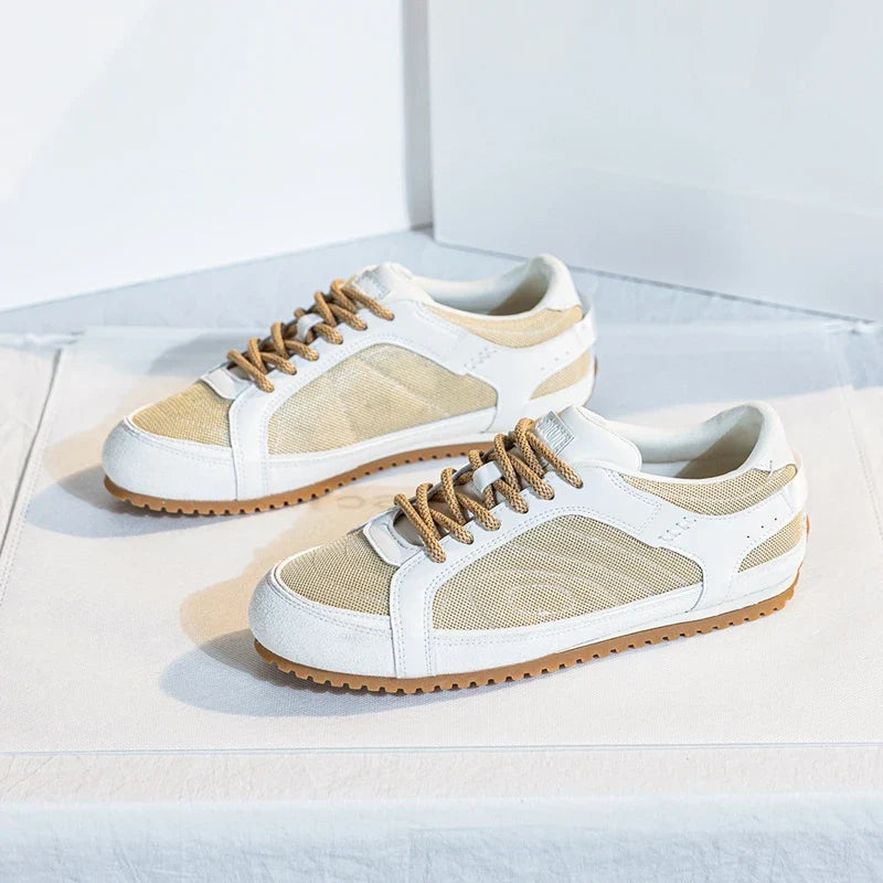 White leather trainers with a sleek, minimalist design and subtle perforations for breathability. 6