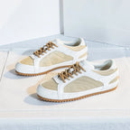 White leather trainers with a sleek, minimalist design and subtle perforations for breathability. 6