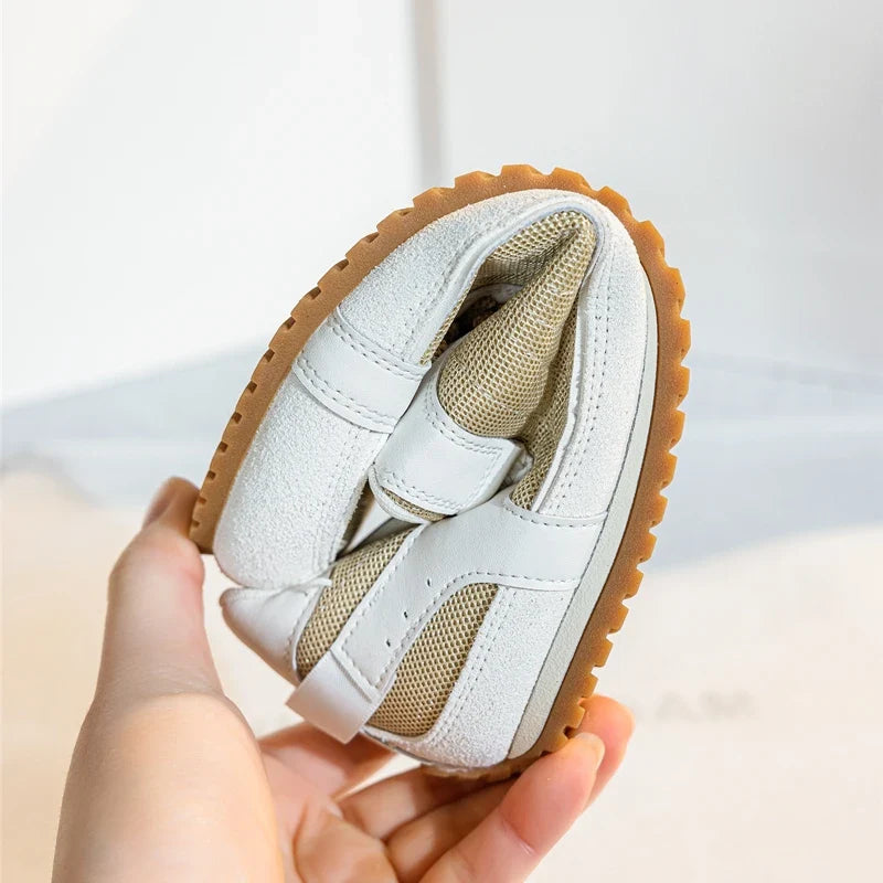 White leather trainers with a sleek, minimalist design and subtle perforations for breathability. 7