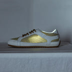 White leather trainers with a sleek, minimalist design and subtle perforations for breathability. 8