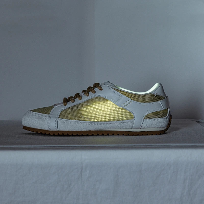 White leather trainers with a sleek, minimalist design and subtle perforations for breathability. 8