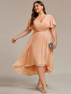 Plus size midi dress in blush pink with a double V-neck and ruffle sleeves, perfect for wedding guests. 13