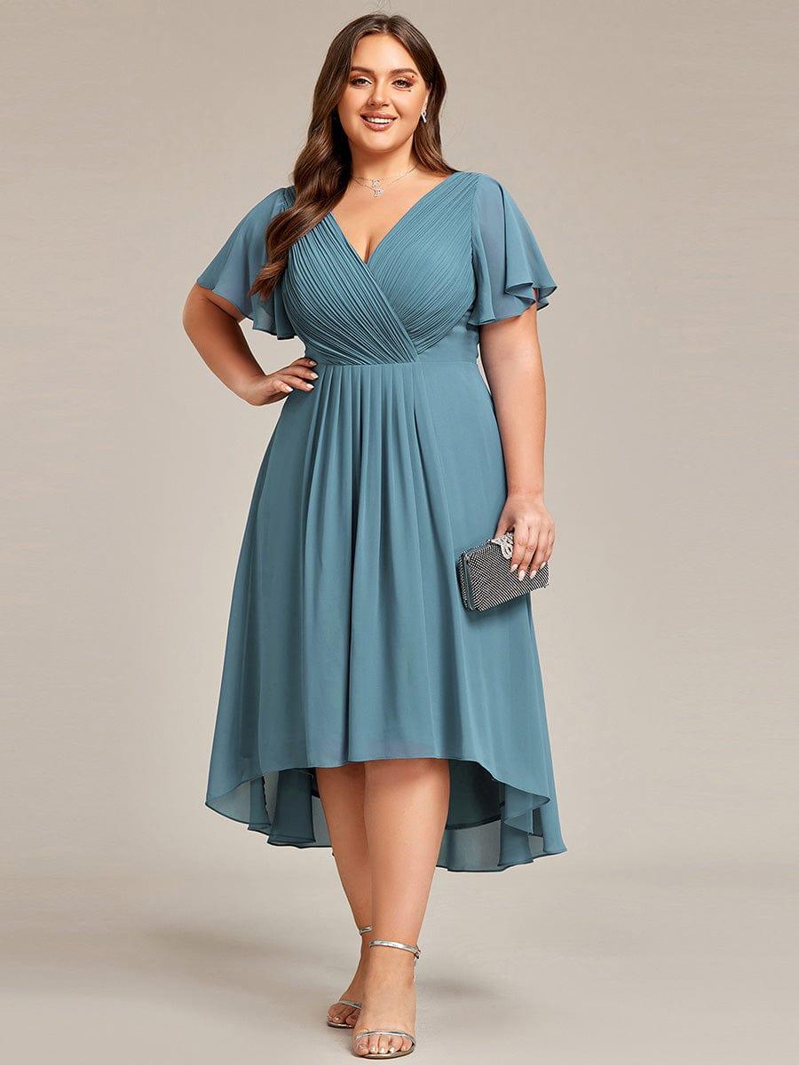 Plus size midi dress in blush pink with a double V-neck and ruffle sleeves, perfect for wedding guests. 15